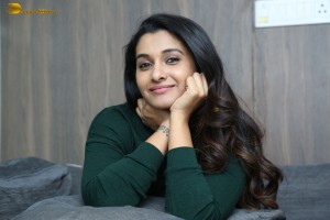actress priya bhavani shankar in a green top and denim jeans
