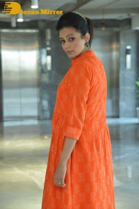 Priyamani photoshoot in a white dress and orange overall jacket