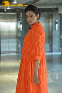 Priyamani photoshoot in a white dress and orange overall jacket