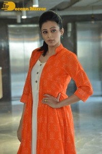 Priyamani photoshoot in a white dress and orange overall jacket
