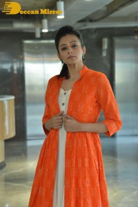 Priyamani photoshoot in a white dress and orange overall jacket