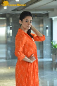 Priyamani photoshoot in a white dress and orange overall jacket