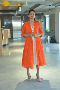 Priyamani photoshoot in a white dress and orange overall jacket