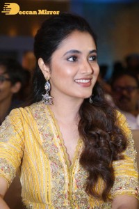 Actress Priyanka Arul Mohan in a yellow dress while attending a movie event