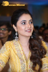 Actress Priyanka Arul Mohan in a yellow dress while attending a movie event