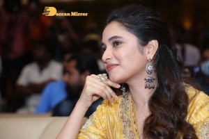 Actress Priyanka Arul Mohan in a yellow dress while attending a movie event