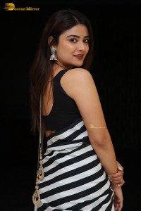 Tollywood Actress Priyanka Sharma in a black and white saree