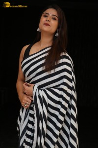 Tollywood Actress Priyanka Sharma in a black and white saree