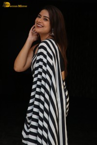 Tollywood Actress Priyanka Sharma in a black and white saree