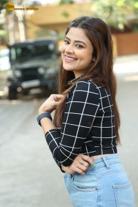 Actress Priyanka Sharma in a black shirt and denim jeans
