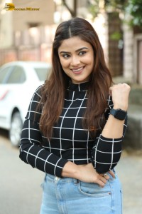 Actress Priyanka Sharma in a black shirt and denim jeans