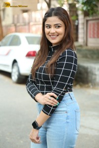 Actress Priyanka Sharma in a black shirt and denim jeans