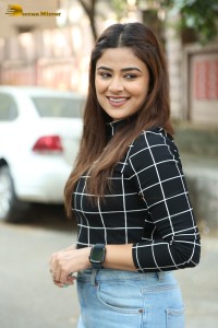 Actress Priyanka Sharma in a black shirt and denim jeans