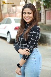 Actress Priyanka Sharma in a black shirt and denim jeans
