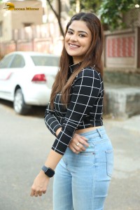 Actress Priyanka Sharma in a black shirt and denim jeans