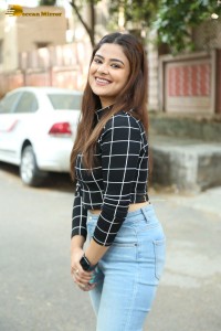 Actress Priyanka Sharma in a black shirt and denim jeans