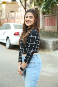 Actress Priyanka Sharma in a black shirt and denim jeans