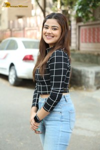 Actress Priyanka Sharma in a black shirt and denim jeans