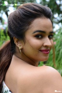 Actress Pujita Ponnada poses in a white floral dress for a photoshoot