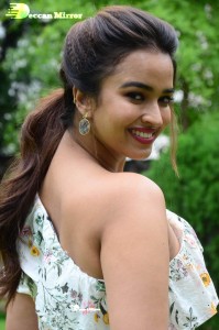 Actress Pujita Ponnada poses in a white floral dress for a photoshoot