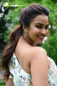 Actress Pujita Ponnada poses in a white floral dress for a photoshoot