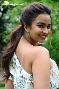 Actress Pujita Ponnada poses in a white floral dress for a photoshoot