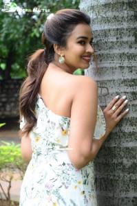 Actress Pujita Ponnada poses in a white floral dress for a photoshoot