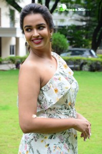 Actress Pujita Ponnada poses in a white floral dress for a photoshoot
