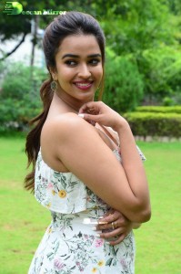 Actress Pujita Ponnada poses in a white floral dress for a photoshoot