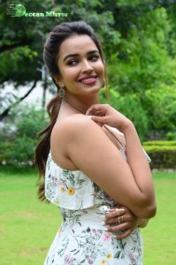 Actress Pujita Ponnada poses in a white floral dress for a photoshoot