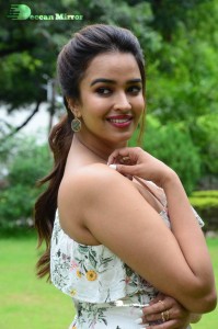 Actress Pujita Ponnada poses in a white floral dress for a photoshoot