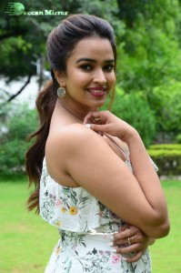 Actress Pujita Ponnada poses in a white floral dress for a photoshoot