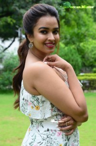 Actress Pujita Ponnada poses in a white floral dress for a photoshoot