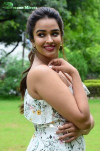 Actress Pujita Ponnada poses in a white floral dress for a photoshoot