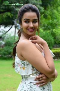 Actress Pujita Ponnada poses in a white floral dress for a photoshoot