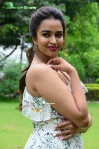 Actress Pujita Ponnada poses in a white floral dress for a photoshoot
