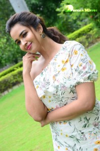 Actress Pujita Ponnada poses in a white floral dress for a photoshoot
