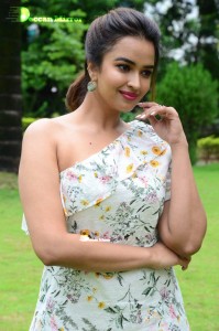 Actress Pujita Ponnada poses in a white floral dress for a photoshoot