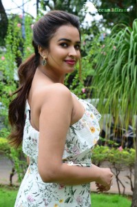 Actress Pujita Ponnada poses in a white floral dress for a photoshoot
