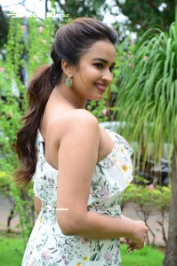 Actress Pujita Ponnada poses in a white floral dress for a photoshoot