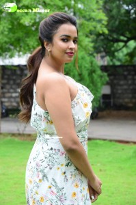 Actress Pujita Ponnada poses in a white floral dress for a photoshoot