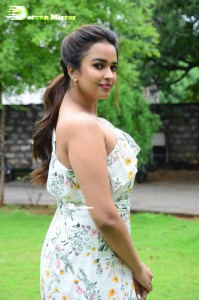 Actress Pujita Ponnada poses in a white floral dress for a photoshoot