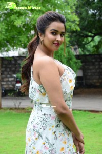 Actress Pujita Ponnada poses in a white floral dress for a photoshoot