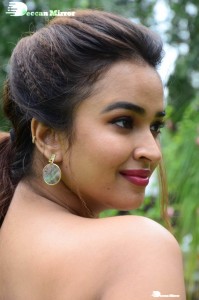 Actress Pujita Ponnada poses in a white floral dress for a photoshoot