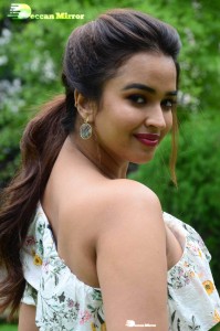 Actress Pujita Ponnada poses in a white floral dress for a photoshoot