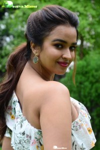 Actress Pujita Ponnada poses in a white floral dress for a photoshoot