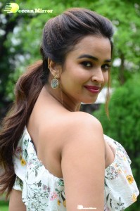 Actress Pujita Ponnada poses in a white floral dress for a photoshoot