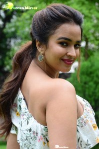 Actress Pujita Ponnada poses in a white floral dress for a photoshoot