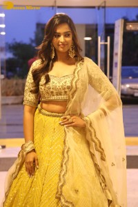 Actress Pujita Ponnada in a yellow dress while attending a movie function