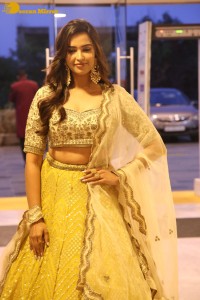 Actress Pujita Ponnada in a yellow dress while attending a movie function